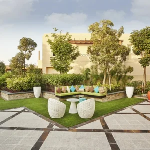 Office Interior Design Trends inspired by biophilic design, blending modern architecture, lush greenery, and functional outdoor collaboration spaces.