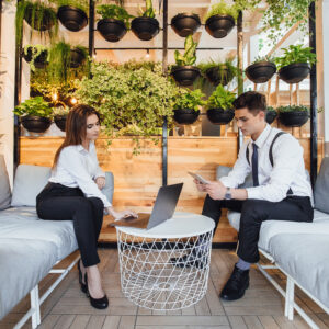 Office Interior Design showcasing a biophilic workspace with integrated greenery, collaborative seating, and a modern environment that enhances employee well-being and productivity.